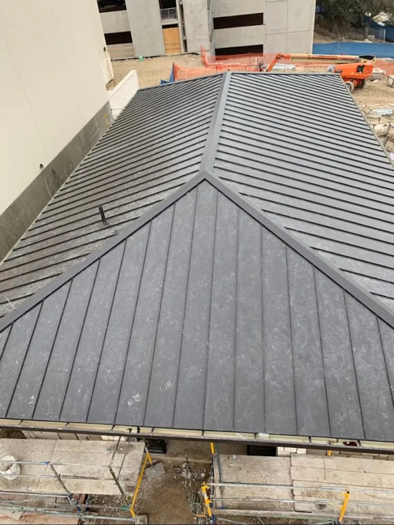 Commercial metal roof construction with crane equipment in Chesterland